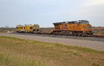 UP 6770 sits in a short siding hooked to a SOO Line flat car and UP EC-4